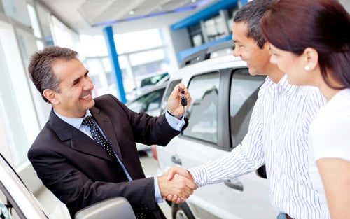 Salesperson shaking hands with ccustomers