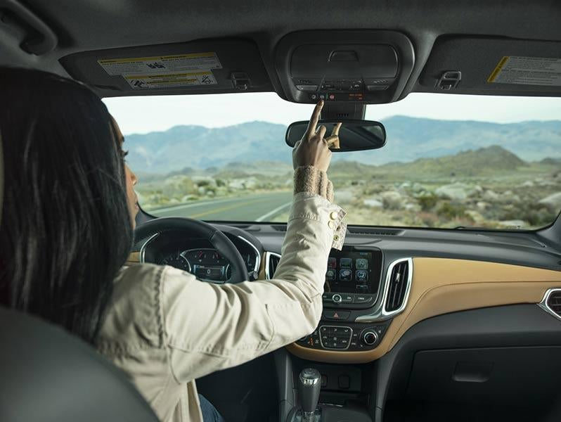 Driver pushing OnStar button